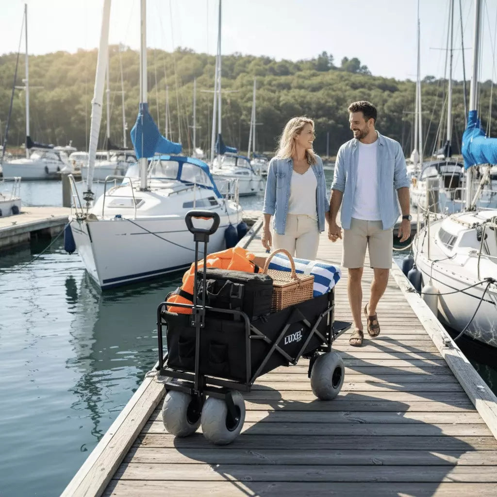 Two people walking with a cart on a dock near boats