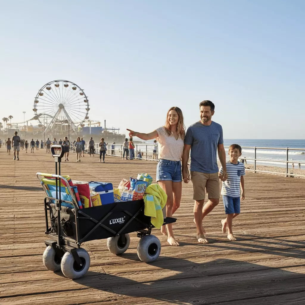 Family with a Luxel beach cart on a wooden pier with a Ferris wheel in the background.
