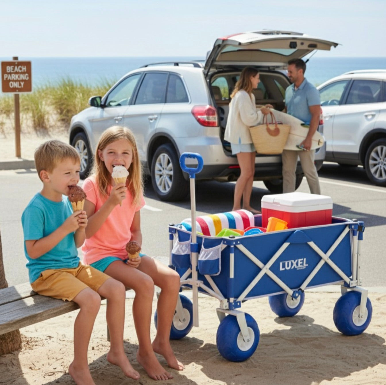 Children eating ice cream by a Luxel beach cart with a cooler and beach items at a beach parking area.