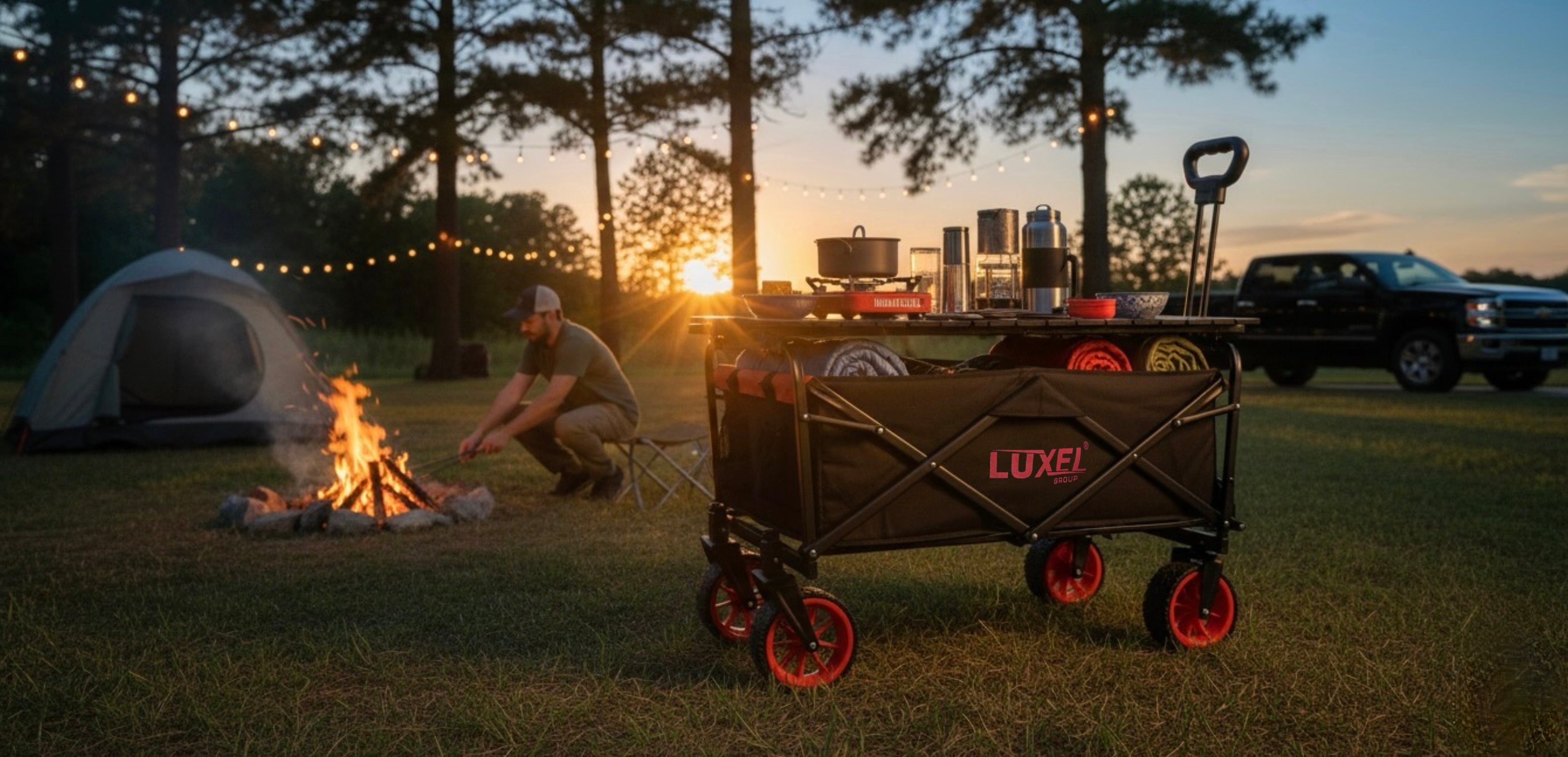 Camping scene with a Luxor wagon, campfire, and tents at sunset.