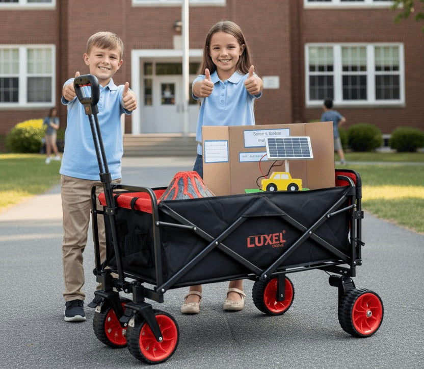 Two children with a black and red wagon in front of a school building