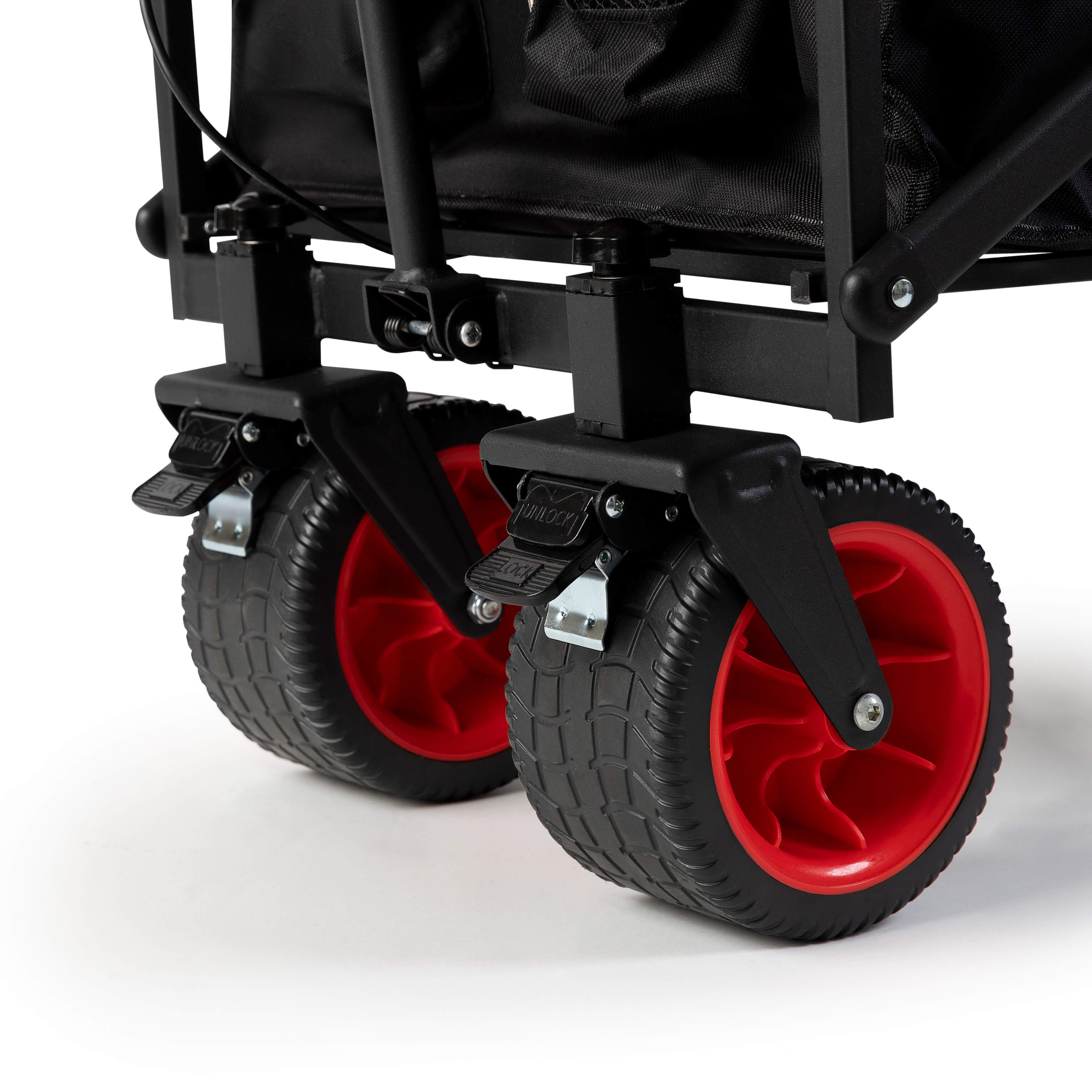 Close-up view of Luxel Group wagon’s double front wheels in black with red rims and built-in foot brakes.